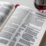Bible verses about communion displayed on open scripture pages with communion bread and wine