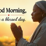 Person praying at sunrise with good morning have a blessed day prayer text overlay, peaceful morning devotion